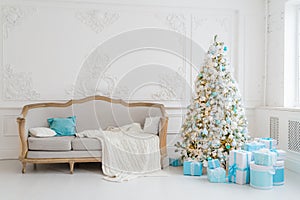 Stylish Christmas interior with an elegant sofa. Comfort home. Presents gifts underneath the tree in living room