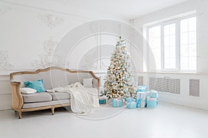 Stylish Christmas interior with an elegant sofa. Comfort home. Presents gifts underneath the tree in living room