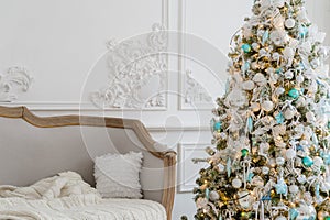 Stylish Christmas interior with an elegant sofa. Comfort home. Presents gifts underneath the tree in living room