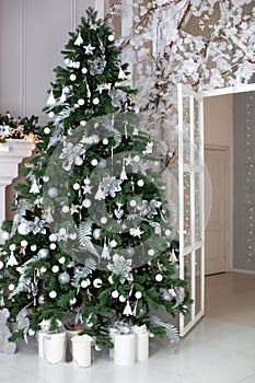 Stylish Christmas living room interior - bright room with Christmas - tree decorations - Christmas trees, gifts at the beautiful g