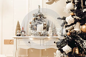 Stylish christmas living room interior with curved furniture, christmas tree and wreath, stars, gifts and decoration
