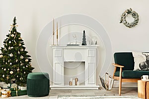 Stylish christmas living room interior with green sofa, white chimney, christmas tree and wreath, gifts and decoration.