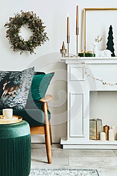 Stylish christmas living room interior with green sofa, white chimney, christmas tree and wreath, stars, gifts and decoration.