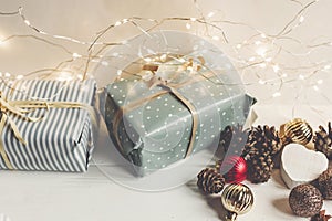 Stylish christmas wrapped presents with ornaments and lights on