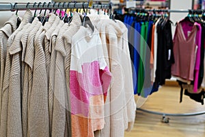 Stylish clothes on hangers in the store