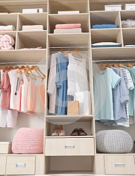 Stylish clothes, shoes and accessories in large wardrobe closet