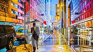 Stylish colorful wet New York NYC commuter with umbrella