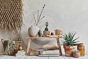 Stylish composition of cozy living room interior with copy space, bench in retro style, clay vase, crockery, straw wall decoration