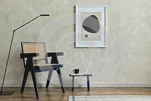 Stylish composition of cozy living room interior with mock up poster frame, wooden armchair, black modern lamp and black tiny.