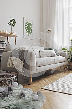 Stylish composition of creative spacious living room interior with modern sofa, wooden furniture, plants, carpet and accessories.