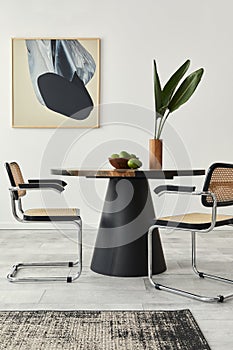 Stylish composition of dining room interior with design table, modern chairs, decoration, tropical leaf in vase, fruits, abstract.