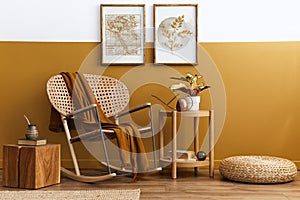 Stylish composition of living room interior with design rattan armchair, two mock up poster frames, plants, cube.