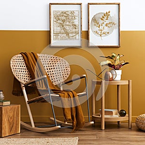 Stylish composition of living room interior with design rattan armchair, two mock up poster frames, plants, cube, plaid.
