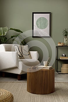 Stylish composition of living room interior with green wall, white armchair with beige pillow, wooden coffee table with books and