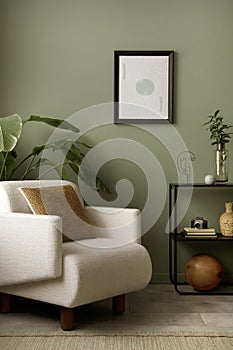 Stylish composition of living room interior with mock up, green wall, white armchair with brown pillow. Brown consola with