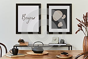 Stylish composition of modern kitchen interior design with mock up poster frames, black console, teapot and kitchen accessories.