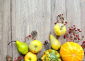 Stylish composition of pumpkins, autumn fruits and berries. Top view on wooden background. Autumn flat lay