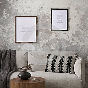 The stylish compostion at living room interior with mock up poster frame, design gray sofa, coffee table, plant, hanger, lamp and photo