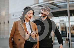 Stylish couple enjoying a casual walk in the urban landscape.