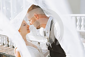 A stylish couple of European newlyweds. Smiling bride in a white dress