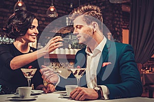 Stylish couple having desert and coffee together in a restaurant.