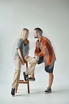 A stylish couple sitting intimately on