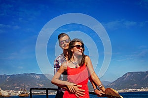 Stylish couple on a wooden yacht
