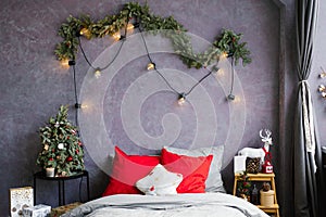 Stylish cozy Christmas bedroom with a large bed and decor