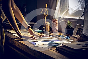 Stylish craftswoman with stationery work at his hipster workstation.