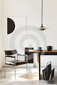 Stylish dining room interior with design wooden family table, black chairs, teapot with mug, mock up art paintings on the wall.
