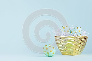 Stylish easter background with blue easter eggs with gold dots in glossy bowl on blue color.