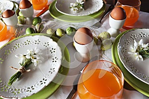 Stylish Easter table setting. Natural egg , snowdrops , modern plate, cutlery. Modern Easter table decoration