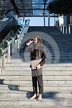 Stylish elegant dreadlocks businessman binoculars