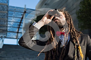 Stylish elegant dreadlocks businessman binoculars