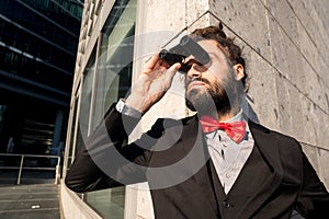 Stylish elegant dreadlocks businessman binoculars