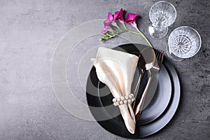 Stylish elegant table setting on grey background. Space for text