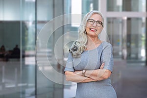 Stylish energetic and enthusiastic business woman CEO smiling with personality at office workplace