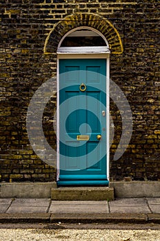 stylish entrance to a residential building, an interesting facade of the old brick arches above the door, a typical old English b