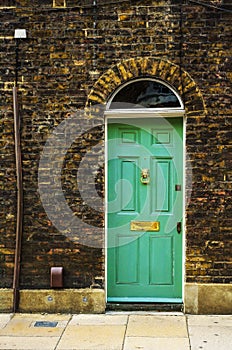 stylish entrance to a residential building, an interesting facade of the old brick arches above the door, a typical old English b