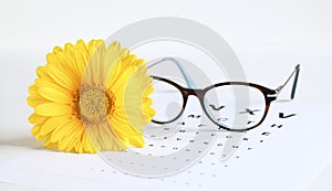 Stylish eyeglasses and eye chart.