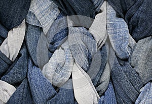 Stylish fabric background of the many braids`s laced in blue jea