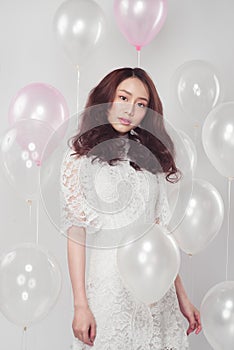 Stylish fashion asian woman with pastel balloons