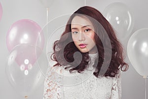 Stylish fashion asian woman with pastel balloons