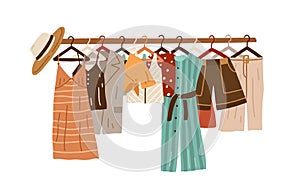 Stylish fashion clothes hanging on hangers on garment rack or rail isolated on white background. Organized women s