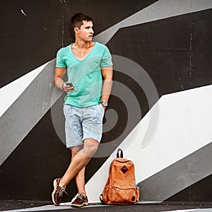 Stylish fashion man traveling with a bag