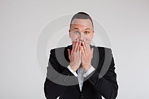 Stylish fashion portraits of a charismatic handsome man in a black tuxedo suit with a bow tie. Emotions, dramatic, close-up.