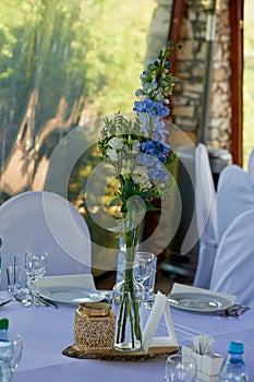 Stylish, fashionable wedding arch ceremony decorated with blue and white different flowers. Floral Design.Summer