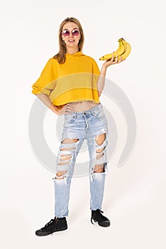 Stylish female with bananas in hand