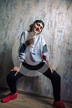 Stylish female street dancer posing to the camera