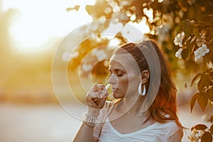 stylish female in white shirt using nasal spray